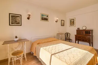 a bedroom with a bed and a table and chairs at Albufeira INN - Av Liberdade T2 in Albufeira