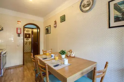 a dining room with a wooden table and chairs at Albufeira INN - Av Liberdade T2 in Albufeira