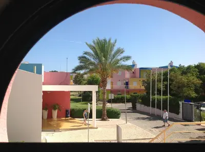 a view of a palm tree and a building at Marina de Albufeira - Apartamentos Turísticos da Orada in Albufeira