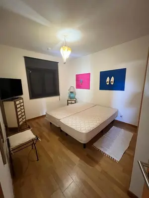 a bedroom with a bed and a tv and a chair at Marina de Albufeira - Apartamentos Turísticos da Orada in Albufeira