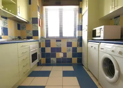 a kitchen with a washing machine and a window at Marina de Albufeira - Apartamentos Turísticos da Orada in Albufeira