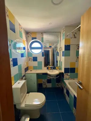 a bathroom with a toilet and a sink and a mirror at Marina de Albufeira - Apartamentos Turísticos da Orada in Albufeira
