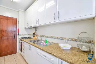 a kitchen with a sink and a counter top at Praia Mar by MTPhomes in Quarteira