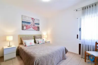 two beds in a white room with blue pillows at Praia Mar by MTPhomes in Quarteira