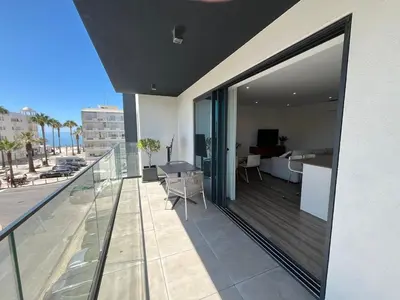 a balcony of a building with a view of a living room at NEW Apartment, Sea Front & Pool in Quarteira