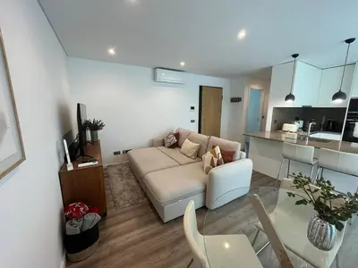 a bathroom with a shower with a tiled wall at NEW Apartment, Sea Front & Pool in Quarteira