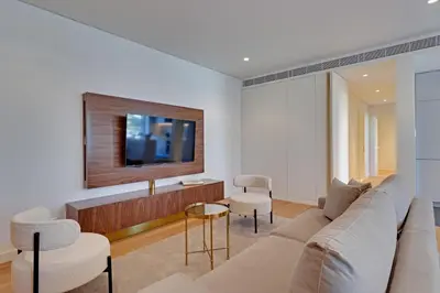 a living room with a couch and a tv at New Beach Apartment in Quarteira
