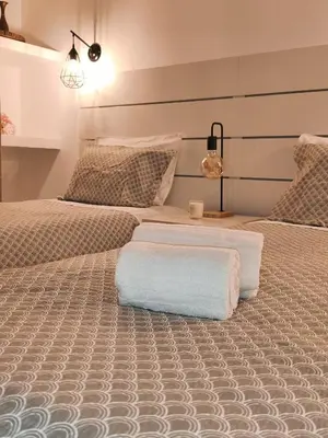 a bedroom with two beds with white pillows at JC HOUSE - T0 - Smart Stay Albufeira - BY BEDZY in Albufeira