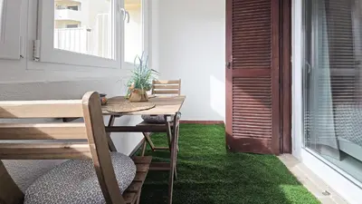 a table and chairs on a balcony with green grass at JC HOUSE - T0 - Smart Stay Albufeira - BY BEDZY in Albufeira