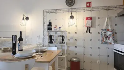 a kitchen with a table with wine glasses on it at JC HOUSE - T0 - Smart Stay Albufeira - BY BEDZY in Albufeira