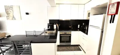 a kitchen with a sink and a living room at Ocean View in Albufeira