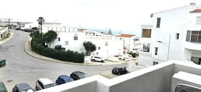a white bathroom with a toilet and a sink at Ocean View in Albufeira