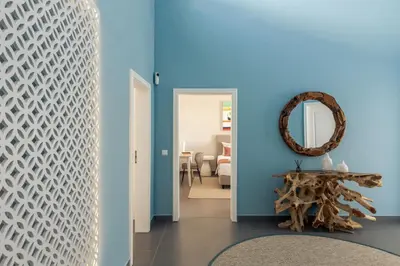a hallway with blue walls and a mirror and a table at Villa e5 in Tunes