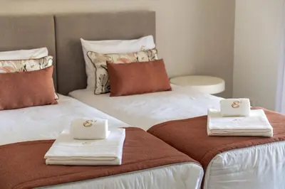 two beds with towels on top of them at Villa e5 in Tunes