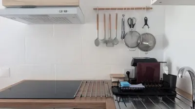a kitchen with a stove and utensils on the wall at Albufeira Spring, Summer & Fall in Albufeira