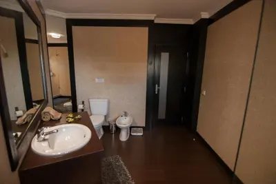 a bathroom with a sink and a toilet and a mirror at Apartamento Albufeira- Descobrimentos in Albufeira