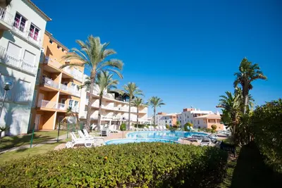 a view of a resort with a swimming pool and palm trees at Apartamento Albufeira- Descobrimentos in Albufeira