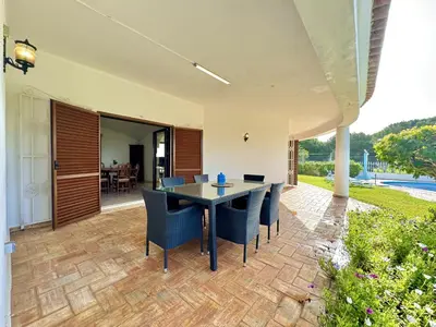 a patio with a table and chairs on it at Vilamoura Summer Villa 2 With Pool by Homing in Vilamoura