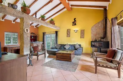 a living room with a couch and a fireplace at Quinta do Mocho in Alcaria