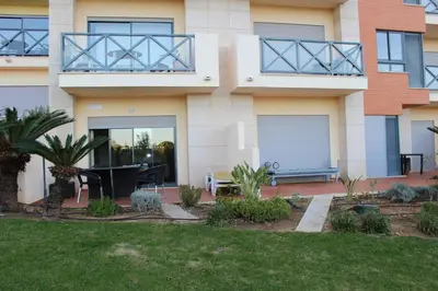 a house with a lawn in front of it at Spacious apartment in Albufeira 200 m² with shared pool in Albufeira