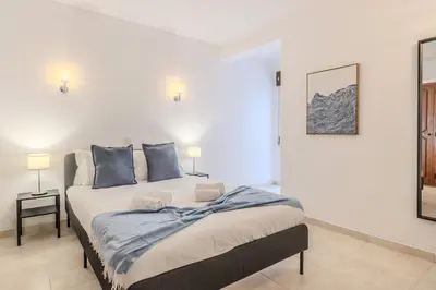 a bedroom with a large bed with blue pillows at #351 Edificio Marina 1 D by Home Holidays in Páteo