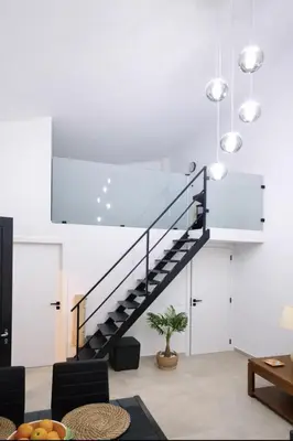a staircase in a living room with white walls at Casa luz e conforto-Casa 20 in Almancil