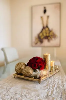 a tray with a bouquet of roses and candles on a table at Dream House in Loulé