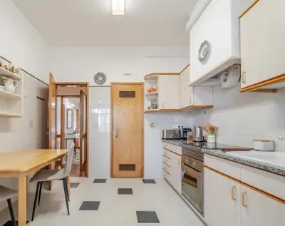 a kitchen with a table and a dining room at Dream House in Loulé