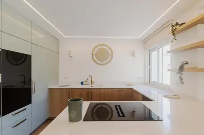 a kitchen with white cabinets and a sink at Villa Juliet in Boliqueime