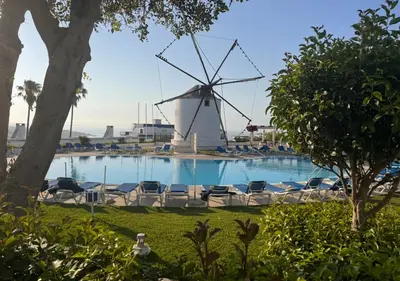 a windmill next to a swimming pool with a windmill at Windmill Hill Apartment in Albufeira