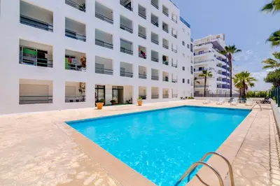 a swimming pool in front of a building at Carteia Beachfront at Praia da Gaivota in Quarteira