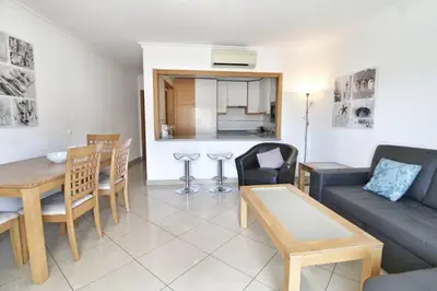 a living room with a couch and a table at Boa Vista Apartment with Sea Views and Shared Pool in Albufeira