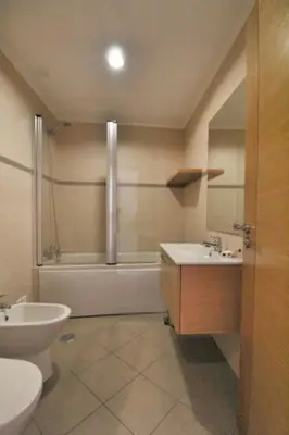 a bathroom with a tub and a sink and a toilet at Boa Vista Apartment with Sea Views and Shared Pool in Albufeira