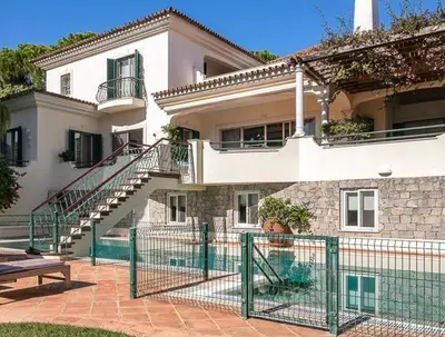 a swimming pool with a table and an umbrella at Traditional property with pool nice large garden in FAO