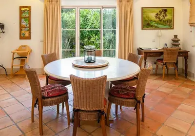a dining room with a table and chairs at Traditional property with pool nice large garden in FAO
