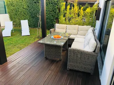 a patio with a couch and a table on a deck at Algarve Family Escape in Olhos de Água