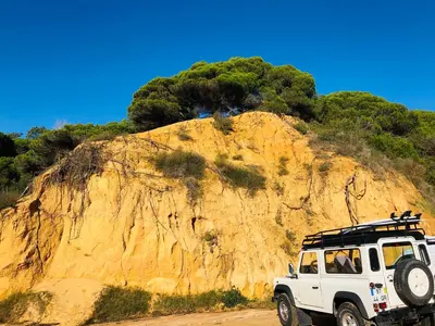 a white jeep parked in front of a mountain at Algarve Family Escape in Olhos de Água