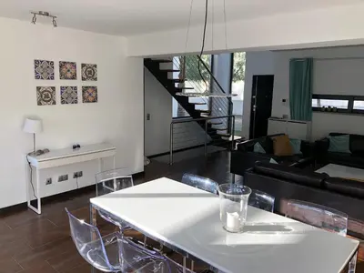 a living room with a white table and chairs at Algarve Family Escape in Olhos de Água