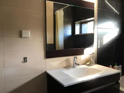 a bathroom with a sink and a mirror at Algarve Family Escape in Olhos de Água