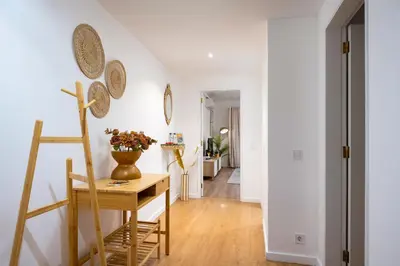 a room with a table and a vase with flowers on it at Vilamoura Marine Prestige in Quarteira