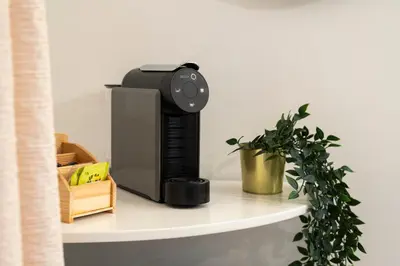 a wireless router sitting on a shelf with a plant at Vilamoura Marine Prestige in Quarteira