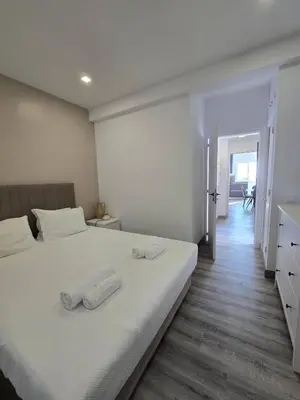 a bedroom with a bed with two towels on it at O Forte by MTPhomes in Albufeira