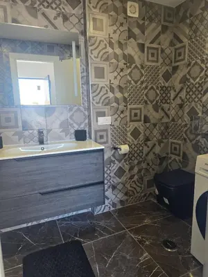a bathroom with a sink and a toilet and a mirror at O Forte by MTPhomes in Albufeira