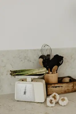a white toaster sitting on a counter with vegetables at Luzico ALGARVE in Loulé