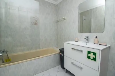 a bathroom with a sink and a bath tub at Top Strip Albufeira in Albufeira