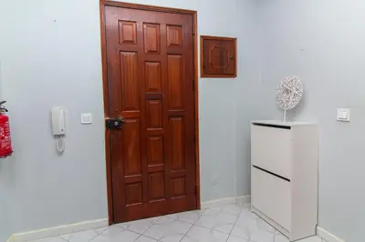 a wooden door in a kitchen with a refrigerator at Top Strip Albufeira in Albufeira