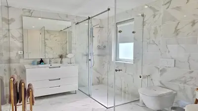 a bathroom with a shower and a toilet and a sink at Villa Barinel by Cleverdetails located in a quiet and privileged area of Vilamoura in Quarteira