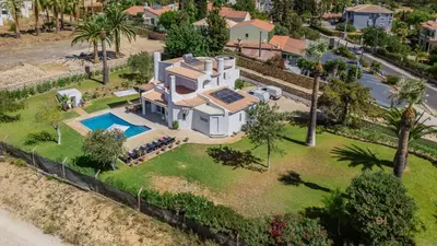 an aerial view of a house with a swimming pool at Greice Homes - Villa Carob Tree in Almancil