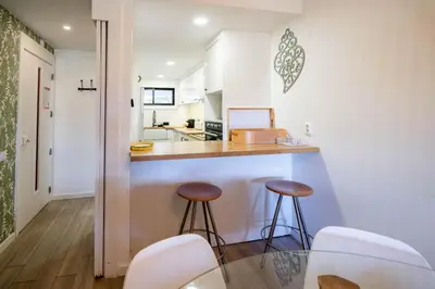 a dining room with a glass table and white chairs at V2 Victory Village in Almancil