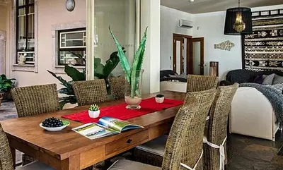 a dining room with a wooden table and chairs at Stunning home with nice pool in Albufeira